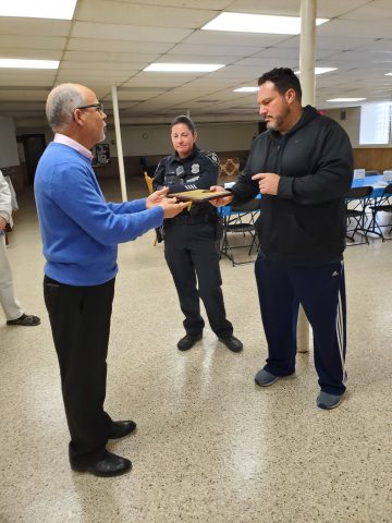 Pastor Carlos Ancheta presenting the plaque to Chief Aaron Goldstein on January 8, 2023.